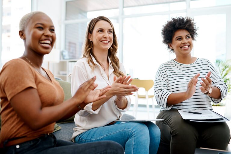 Shot of a group of businesswomen applauding in an office
